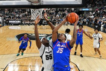 Feb 7, 2026; Providence, Rhode Island, USA; DePaul Blue Demons forward N.J. Benson (35) shoots the ball against Providence Friars forward Oswin Erhunmwunse (55) during the second half at Amica Mutual Pavilion. Mandatory Credit: Eric Canha-Imagn Images
