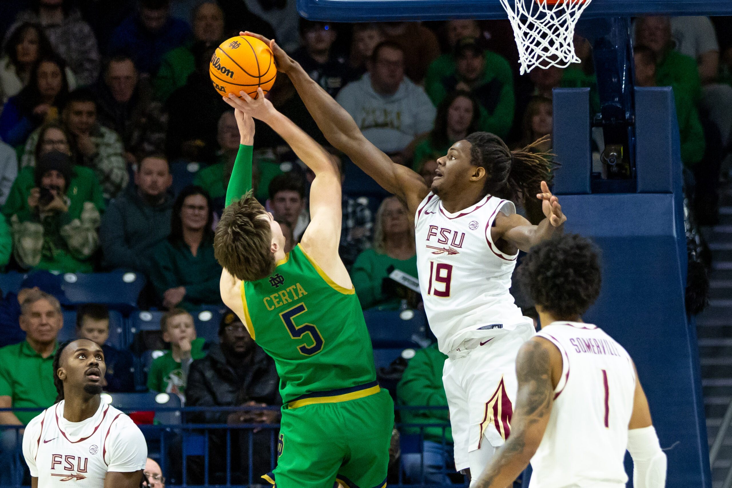Feb 7, 2026; South Bend, Indiana, USA; Florida State Seminoles forward AJ Swinton (19) blocks Notre Dame Fighting Irish guard Cole Certa (5) during the second half at Purcell Pavilion at the Joyce Center. Mandatory Credit: Michael Caterina-Imagn Images