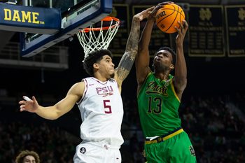 Feb 7, 2026; South Bend, Indiana, USA; Notre Dame Fighting Irish guard Sir Mohammed (13) and Florida State Seminoles guard Kobe Magee (5) fight for a rebound during the second half at Purcell Pavilion at the Joyce Center. Mandatory Credit: Michael Caterina-Imagn Images