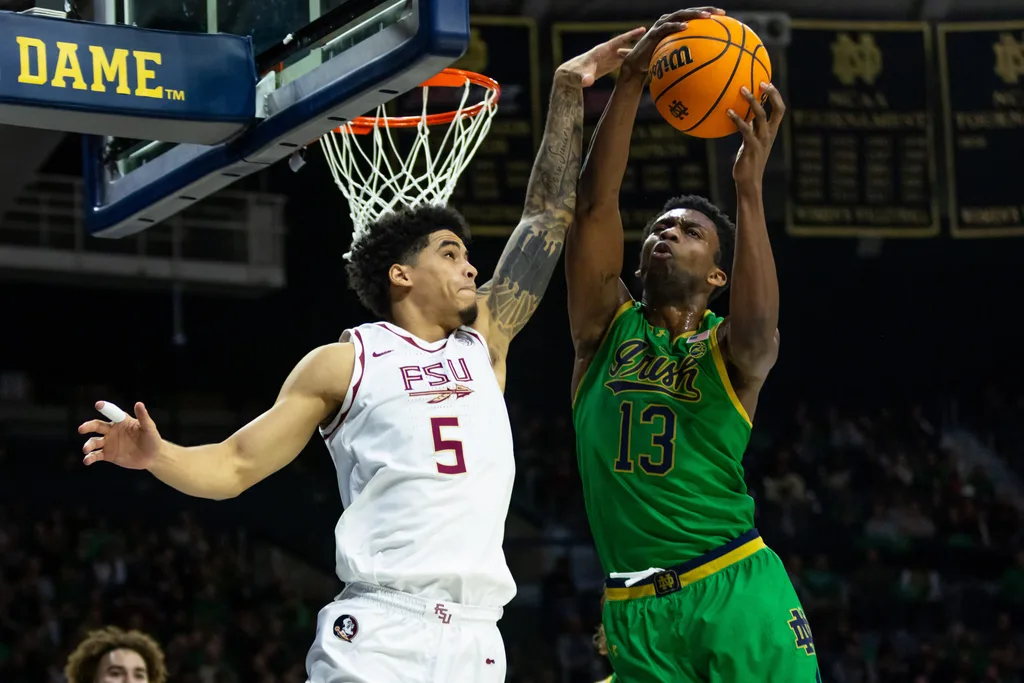 Feb 7, 2026; South Bend, Indiana, USA; Notre Dame Fighting Irish guard Sir Mohammed (13) and Florida State Seminoles guard Kobe Magee (5) fight for a rebound during the second half at Purcell Pavilion at the Joyce Center. Mandatory Credit: Michael Caterina-Imagn Images