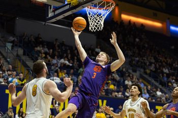 Feb 7, 2026; Berkeley, California, USA; Clemson Tigers forward Chase Thompson (3) lays the ball up between California Golden Bears defenders Milos Ilić (8) and Justin Pippen (10) during the first half at Haas Pavilion. Mandatory Credit: D. Ross Cameron-Imagn Images