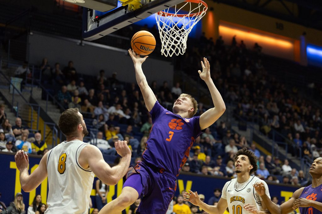 Feb 7, 2026; Berkeley, California, USA; Clemson Tigers forward Chase Thompson (3) lays the ball up between California Golden Bears defenders Milos Ilić (8) and Justin Pippen (10) during the first half at Haas Pavilion. Mandatory Credit: D. Ross Cameron-Imagn Images
