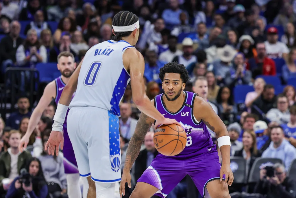 Feb 7, 2026; Orlando, Florida, USA; Utah Jazz forward Brice Sensabaugh (28) defends Orlando Magic guard Anthony Black (0) during the second half at Kia Center. Mandatory Credit: Mike Watters-Imagn Images
