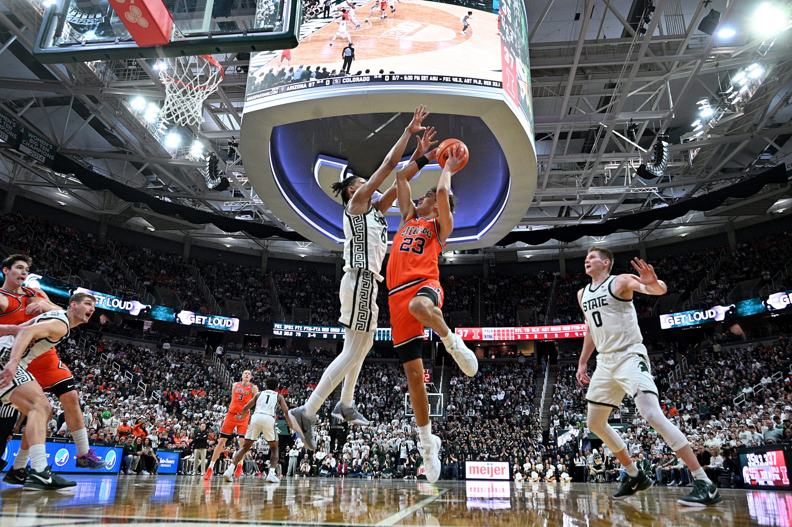 Feb 7, 2026; East Lansing, Michigan, USA;  Illinois Fighting Illini guard Keaton Wagler (23) draws a foul from Michigan State Spartans forward Jordan Scott (6) during the first half at Jack Breslin Student Events Center. Mandatory Credit: Dale Young-Imagn Images