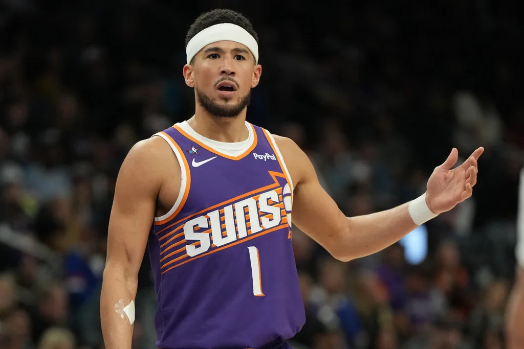 Feb 7, 2026; Phoenix, Arizona, USA; Phoenix Suns guard Devin Booker (1) reacts after a foul call against the Philadelphia 76ers during the second half of an NBA game at Mortgage Matchup Center. Mandatory Credit: Rick Scuteri-Imagn Images