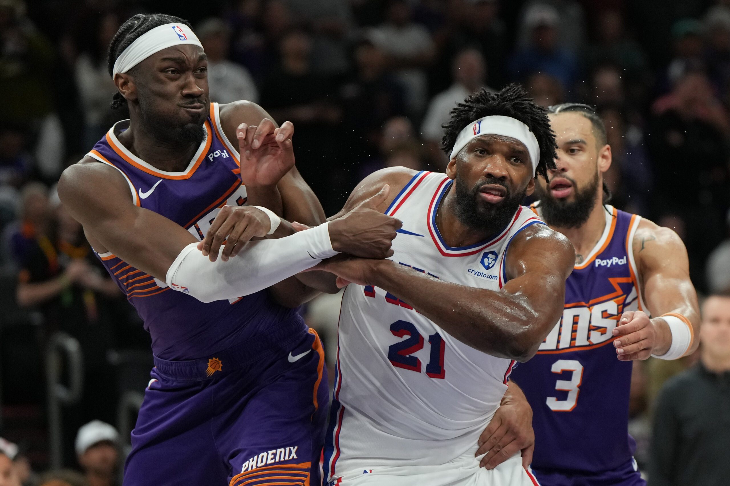 Feb 7, 2026; Phoenix, Arizona, USA; Philadelphia 76ers center Joel Embiid (21) battles for position against Phoenix Suns center Mark Williams (15) and forward Dillon Brooks (3) during the second half of an NBA game at Mortgage Matchup Center. Mandatory Credit: Rick Scuteri-Imagn Images