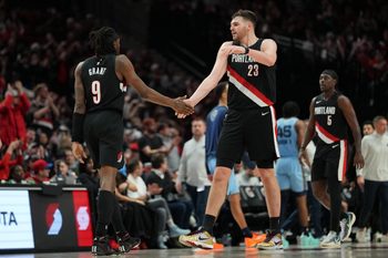 Feb 7, 2026; Portland, Oregon, USA; Portland Trail Blazers forward Jerami Grant (9) celebrates after making a three-point basket with teammate Donovan Clingan (23) during the second half against the Memphis Grizzlies at Moda Center. Mandatory Credit: Soobum Im-Imagn Images