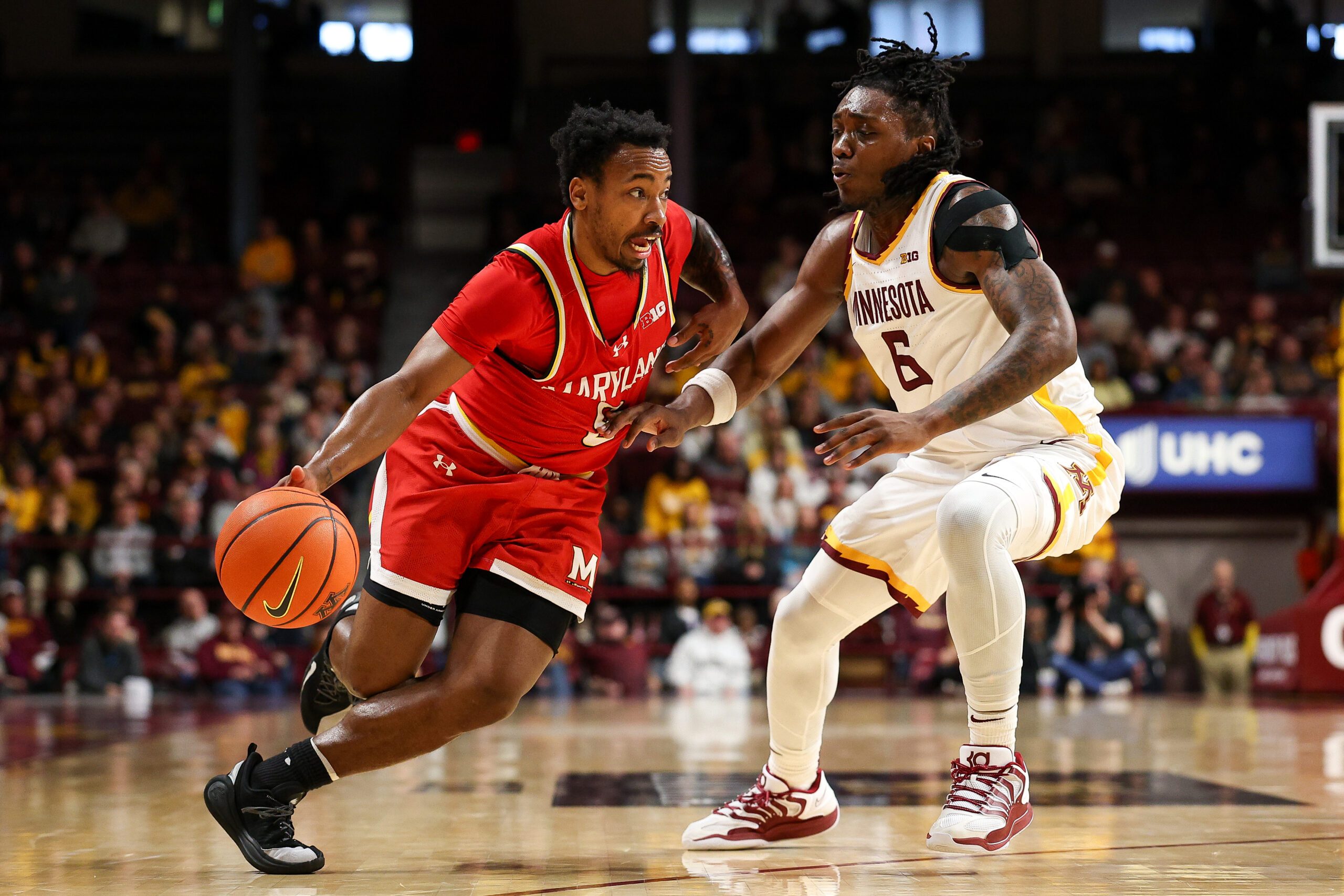 Feb 8, 2026; Minneapolis, Minnesota, USA; Maryland Terrapins guard David Coit (8) works around Minnesota Golden Gophers guard Langston Reynolds (6) during the second half at Williams Arena. Mandatory Credit: Matt Krohn-Imagn Images