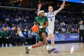 Feb 8, 2026; Memphis, Tennessee, USA; Charlotte 49ers guard Damoni Harrison (10) drives to the basket against Memphis Tigers forward Mason Matthews (8) during the second half at FedExForum. Mandatory Credit: Wesley Hale-Imagn Images