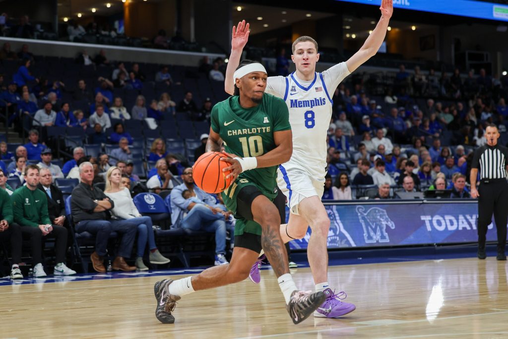 Feb 8, 2026; Memphis, Tennessee, USA; Charlotte 49ers guard Damoni Harrison (10) drives to the basket against Memphis Tigers forward Mason Matthews (8) during the second half at FedExForum. Mandatory Credit: Wesley Hale-Imagn Images