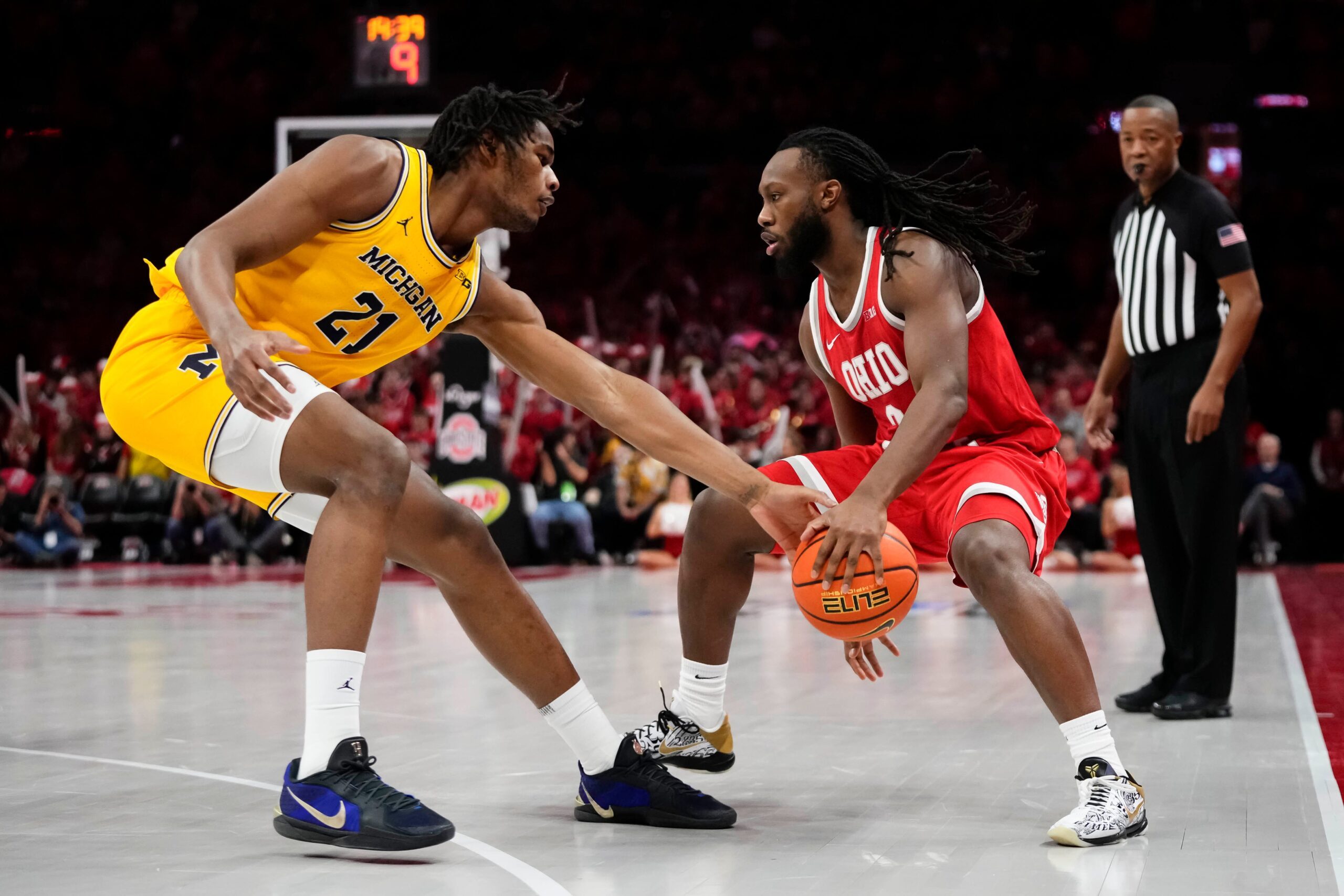 Ohio State Buckeyes guard Bruce Thornton (2) dribbles around Michigan Wolverines forward Morez Johnson Jr. (21) during the NCAA men's basketball game at the Schottenstein Center in Columbus on Feb. 8, 2026.