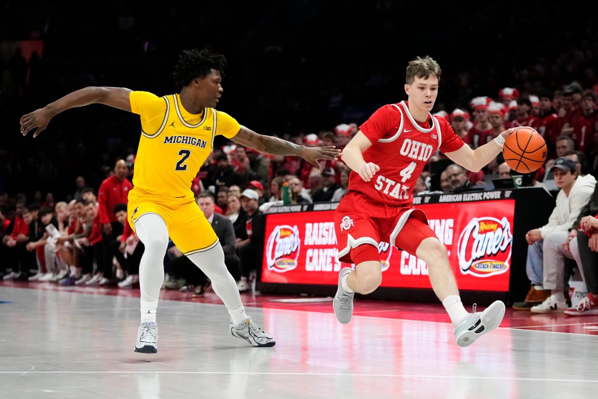 Ohio State Buckeyes guard Gabe Cupps (4) dribbles past Michigan Wolverines guard L.J. Cason (2) during the NCAA men's basketball game at the Schottenstein Center in Columbus on Feb. 8, 2026.