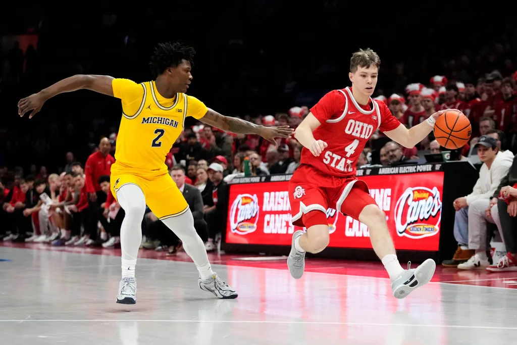 Ohio State Buckeyes guard Gabe Cupps (4) dribbles past Michigan Wolverines guard L.J. Cason (2) during the NCAA men's basketball game at the Schottenstein Center in Columbus on Feb. 8, 2026.