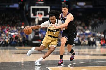 Feb 8, 2026; Washington, District of Columbia, USA;  Washington Wizards guard Bub Carrington (7) attempts to dibble past Miami Heat forward Simone Fontecchio (0) during the fourth quarter at Capital One Arena. Mandatory Credit: Rafael Suanes-Imagn Images