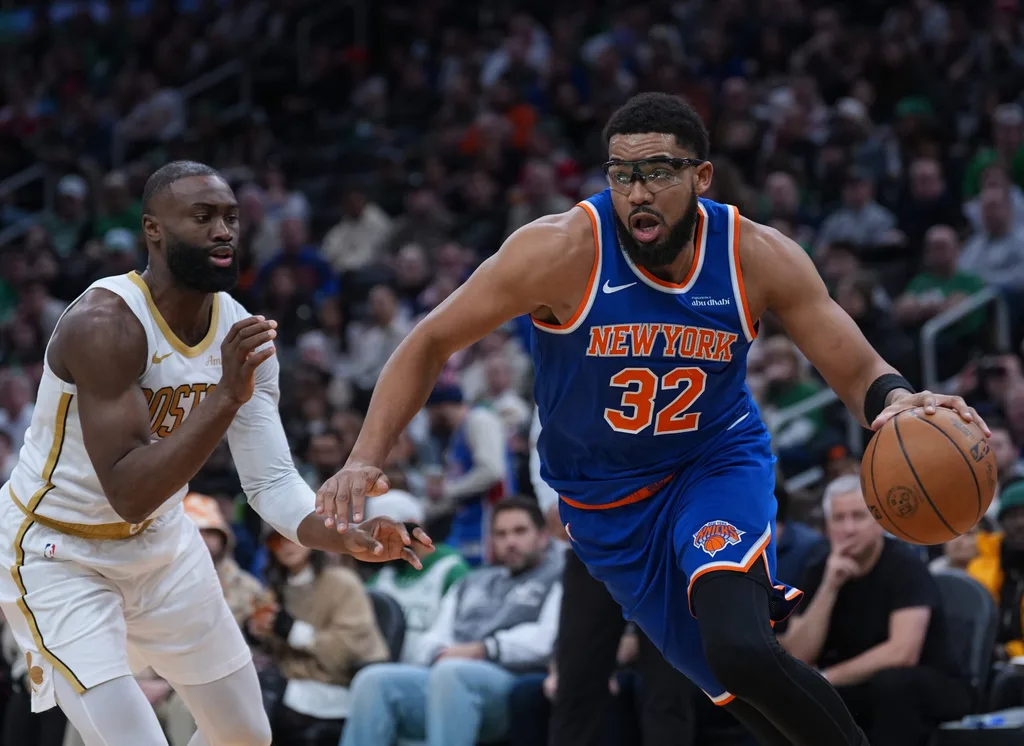Feb 8, 2026; Boston, Massachusetts, USA; New York Knicks center Karl-Anthony Towns (32) drives the ball against Boston Celtics guard Jaylen Brown (7) in the second quarter at TD Garden. Mandatory Credit: David Butler II-Imagn Images