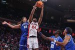 Feb 9, 2026; New York, New York, USA;  St. John's Red Storm forward Zuby Ejiofor (24) grab a rebound away from Xavier Musketeers forward Tre Carroll (12) in the second half at Madison Square Garden Mandatory Credit: Wendell Cruz-Imagn Images