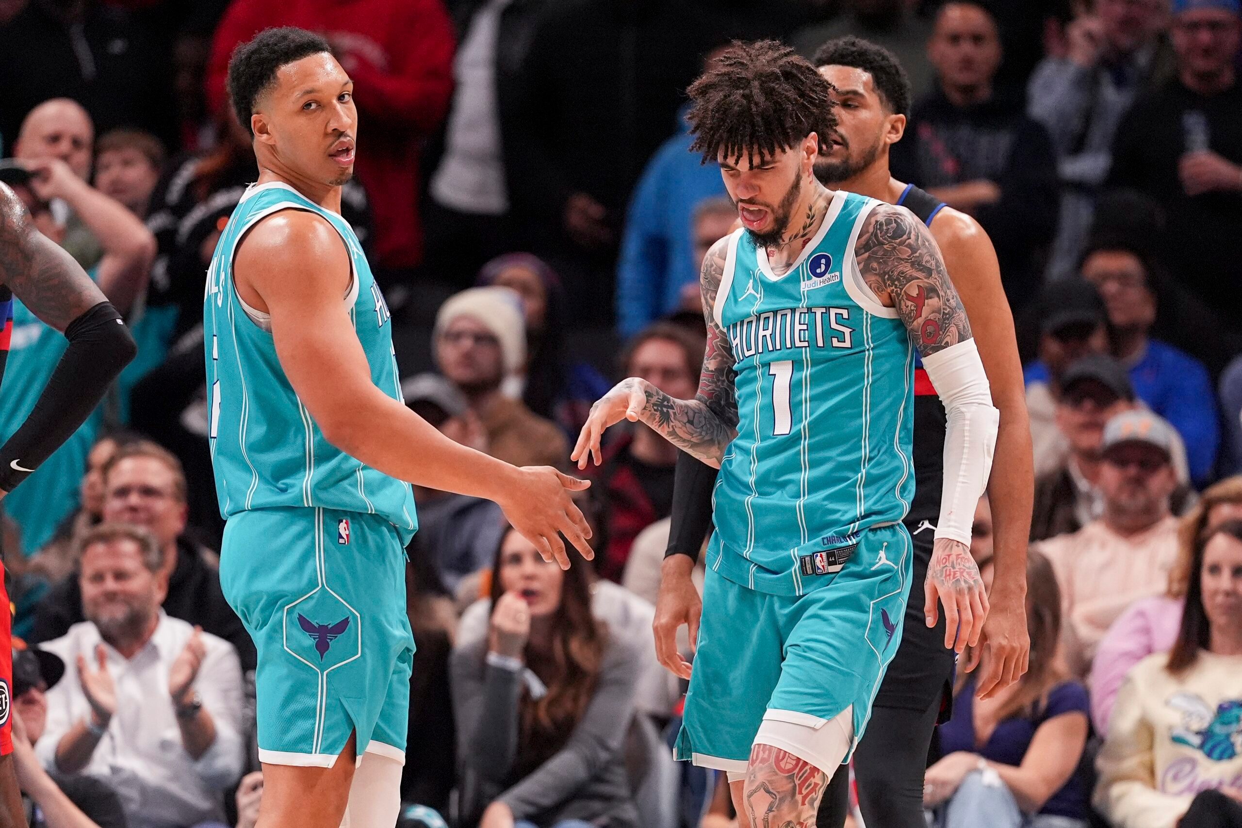 Feb 9, 2026; Charlotte, North Carolina, USA; Charlotte Hornets guard LaMelo Ball (1) and forward Grant Williams (2) after a thee point play against the Detroit Pistons during the second half at Spectrum Center. Mandatory Credit: Jim Dedmon-Imagn Images