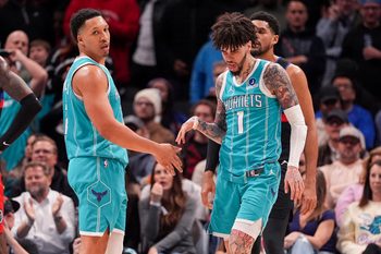 Feb 9, 2026; Charlotte, North Carolina, USA; Charlotte Hornets guard LaMelo Ball (1) and forward Grant Williams (2) after a thee point play against the Detroit Pistons during the second half at Spectrum Center. Mandatory Credit: Jim Dedmon-Imagn Images