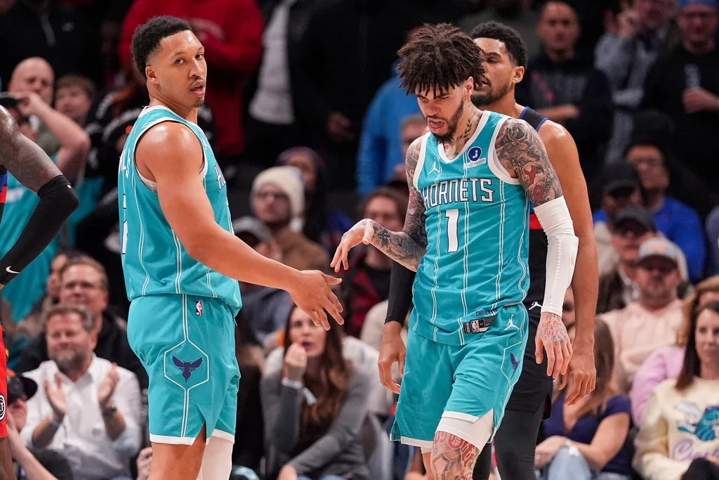 Feb 9, 2026; Charlotte, North Carolina, USA; Charlotte Hornets guard LaMelo Ball (1) and forward Grant Williams (2) after a thee point play against the Detroit Pistons during the second half at Spectrum Center. Mandatory Credit: Jim Dedmon-Imagn Images