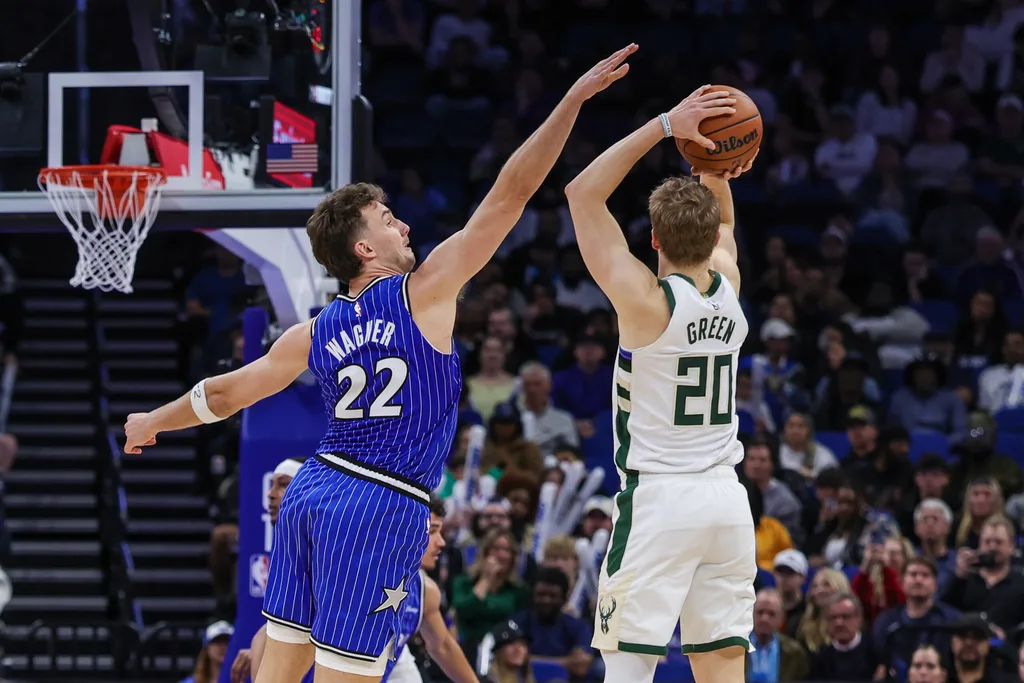 Feb 9, 2026; Orlando, Florida, USA; Orlando Magic forward Franz Wagner (22) defends Milwaukee Bucks guard AJ Green (20) during the second half at Kia Center. Mandatory Credit: Mike Watters-Imagn Images