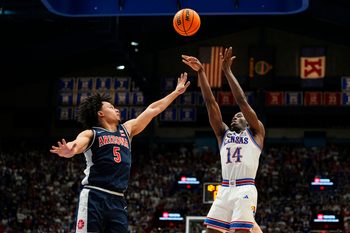 Feb 9, 2026; Lawrence, Kansas, USA; Kansas Jayhawks guard Melvin Council Jr. (14) shoots against Arizona Wildcats guard Brayden Burries (5) during the second half at Allen Fieldhouse. Mandatory Credit: Jay Biggerstaff-Imagn Images