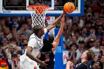 Feb 9, 2026; Lawrence, Kansas, USA; Kansas Jayhawks forward Flory Bidunga (40) blocks the shot of Arizona Wildcats guard Brayden Burries (5) during the second half at Allen Fieldhouse. Mandatory Credit: Jay Biggerstaff-Imagn Images