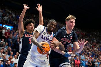 Feb 9, 2026; Lawrence, Kansas, USA; Kansas Jayhawks forward Flory Bidunga (40) and Arizona Wildcats center Motiejus Krivas (13) fight for a rebound during the second half at Allen Fieldhouse. Mandatory Credit: Jay Biggerstaff-Imagn Images