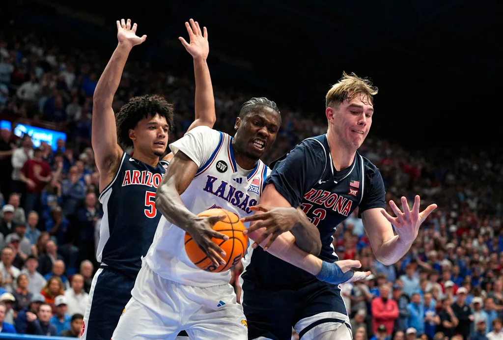 Feb 9, 2026; Lawrence, Kansas, USA; Kansas Jayhawks forward Flory Bidunga (40) and Arizona Wildcats center Motiejus Krivas (13) fight for a rebound during the second half at Allen Fieldhouse. Mandatory Credit: Jay Biggerstaff-Imagn Images