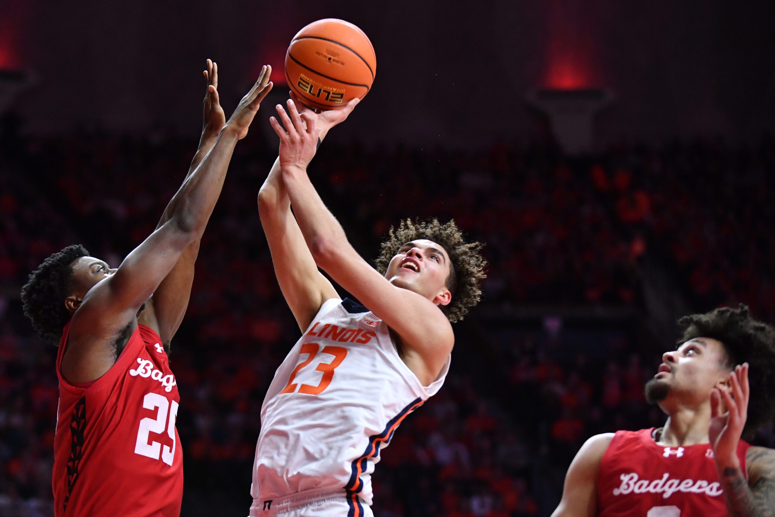 Feb 10, 2026; Champaign, Illinois, USA;  Illinois Fighting Illini guard Keaton Wagler (23) shoots the ball over Wisconsin Badgers guard John Blackwell (25) during the first half at State Farm Center. Mandatory Credit: Ron Johnson-Imagn Images