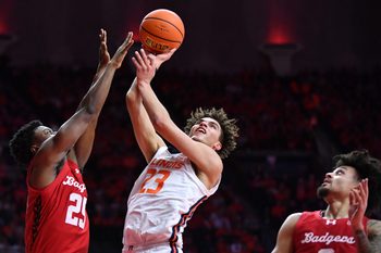 Feb 10, 2026; Champaign, Illinois, USA;  Illinois Fighting Illini guard Keaton Wagler (23) shoots the ball over Wisconsin Badgers guard John Blackwell (25) during the first half at State Farm Center. Mandatory Credit: Ron Johnson-Imagn Images