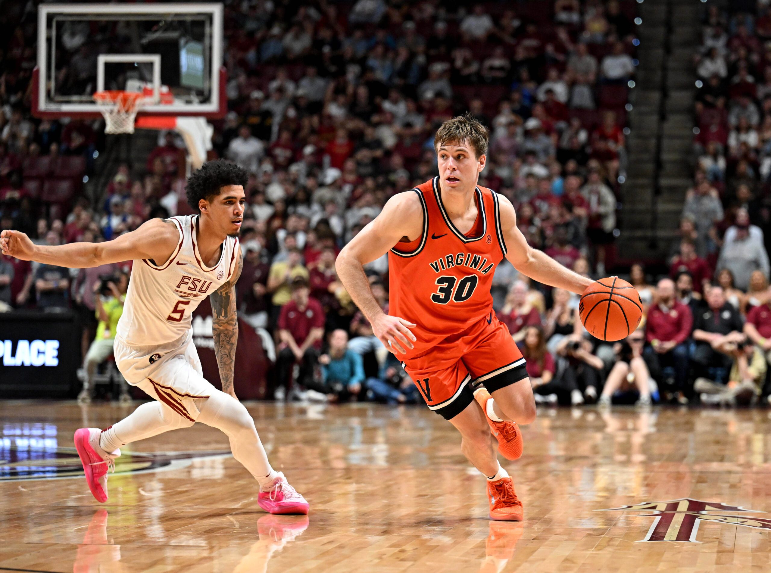 Feb 10, 2026; Tallahassee, Florida, USA; Virginia Cavaliers guard Dallin Hall (30) drives the ball up the court past Florida State Seminoles guard Kobe Magee (5) during the second half at Donald L. Tucker Center. Mandatory Credit: Melina Myers-Imagn Images