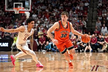 Feb 10, 2026; Tallahassee, Florida, USA; Virginia Cavaliers guard Dallin Hall (30) drives the ball up the court past Florida State Seminoles guard Kobe Magee (5) during the second half at Donald L. Tucker Center. Mandatory Credit: Melina Myers-Imagn Images