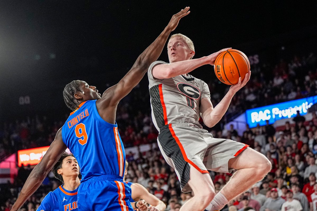 Feb 11, 2026; Athens, Georgia, USA; Georgia Bulldogs guard Blue Cain (0) looks to pass against Florida Gators center Rueben Chinyelu (9) during the first half at Stegeman Coliseum. Mandatory Credit: Dale Zanine-Imagn Images