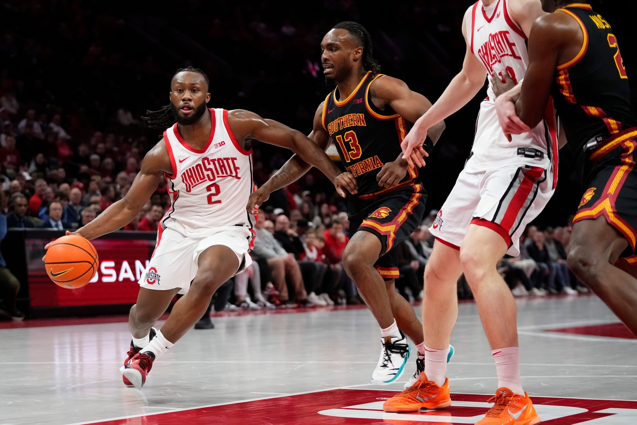 Ohio State Buckeyes guard Bruce Thornton (2) drives past USC Trojans guard Kam Woods (13) during the first half of the NCAA men's basketball game at the Schottenstein Center on Feb. 11, 2026.