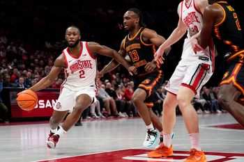 Ohio State Buckeyes guard Bruce Thornton (2) drives past USC Trojans guard Kam Woods (13) during the first half of the NCAA men's basketball game at the Schottenstein Center on Feb. 11, 2026.