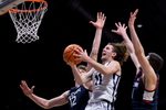 Feb 11, 2026; Indianapolis, Indiana, USA; Butler Bulldogs guard Finley Bizjack (11) shoots past UConn Huskies center Eric Reibe (12) during the second half at Hinkle Fieldhouse. Mandatory Credit: Robert Goddin-Imagn Images