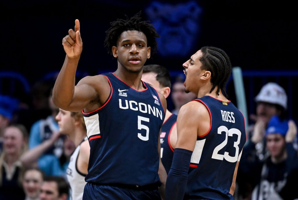 Feb 11, 2026; Indianapolis, Indiana, USA; UConn Huskies center Tarris Reed Jr. (5) celebrates with UConn Huskies forward Jayden Ross (23) against the Butler Bulldogs during the second half at Hinkle Fieldhouse. Mandatory Credit: Robert Goddin-Imagn Images