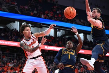 Feb 11, 2026; Syracuse, New York, USA; Syracuse Orange guard Nate Kingz (4) passes the ball as California Golden Bears center Milos Ilic (8) and guard Dejuan Campbell (1) defend in the second half at the JMA Wireless Dome. Mandatory Credit: Mark Konezny-Imagn Images