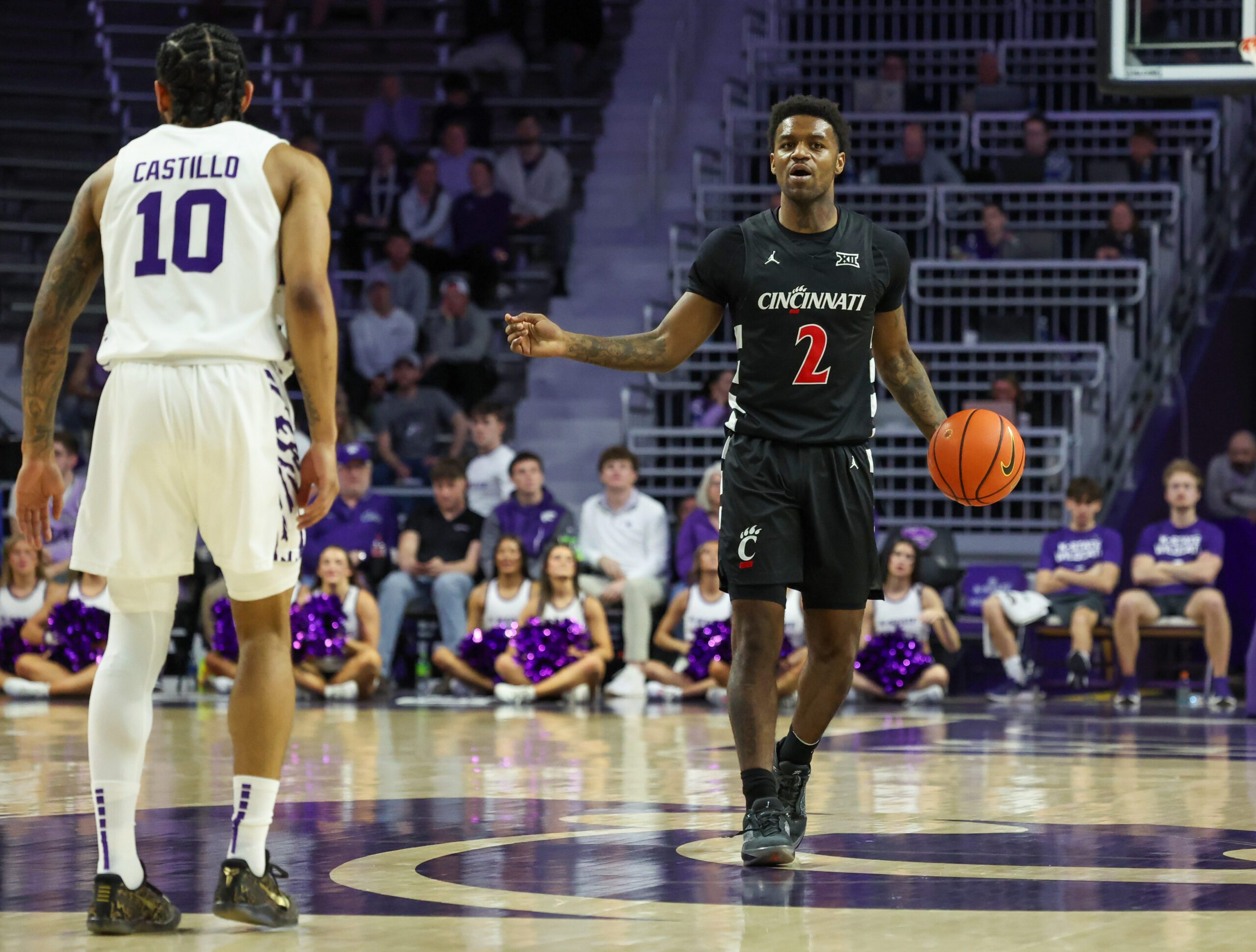 Feb 11, 2026; Manhattan, Kansas, USA; Cincinnati Bearcats guard Jizzle James (2) brings the ball up court against Kansas State Wildcats guard David Castillo (10) during the first half at Bramlage Coliseum. Mandatory Credit: Scott Sewell-Imagn Images