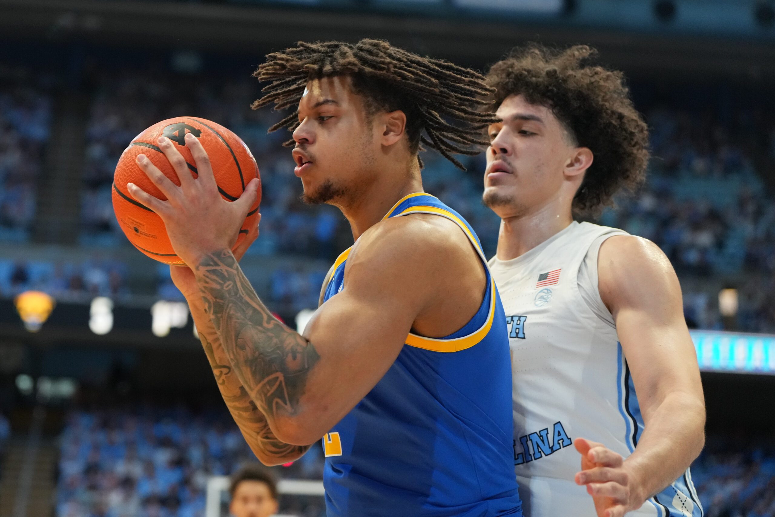 Feb 14, 2026; Chapel Hill, North Carolina, USA; Pittsburgh Panthers forward Cameron Corhen (2) with the ball as North Carolina Tar Heels forward Zayden High (1) defends in the first half at Dean E. Smith Center. Mandatory Credit: Bob Donnan-Imagn Images