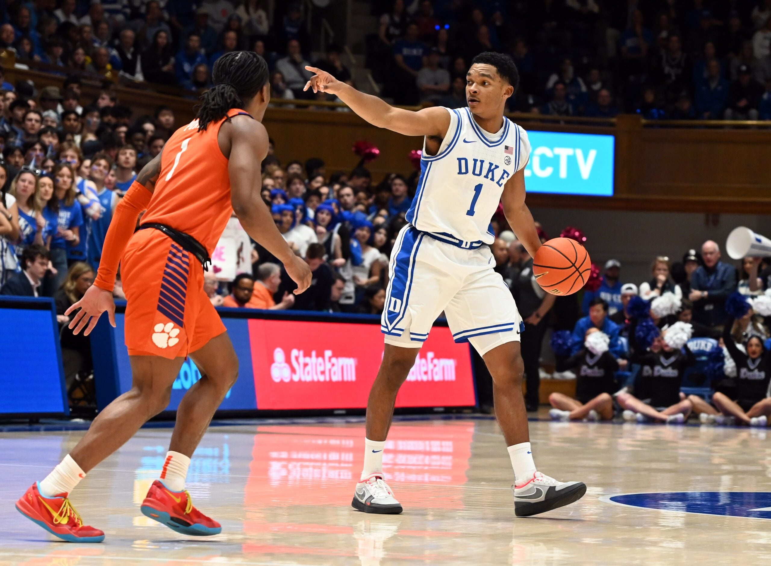 Feb 14, 2026; Durham, North Carolina, USA;Duke Blue Devils guard Caleb Foster (1) directs the offense as Clemson Tigers guard Jestin Porter (1) defends during the second half at Cameron Indoor Stadium. Mandatory Credit: Rob Kinnan-Imagn Images