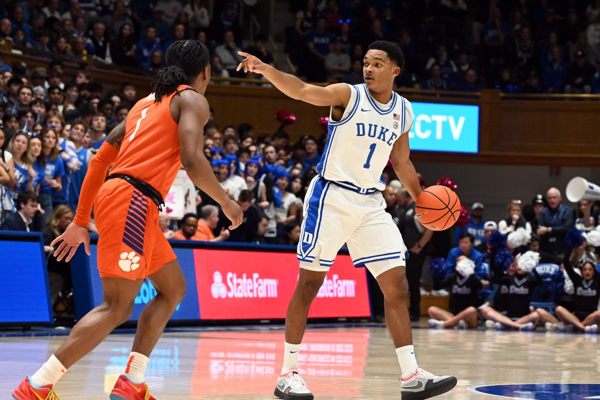 Feb 14, 2026; Durham, North Carolina, USA;Duke Blue Devils guard Caleb Foster (1) directs the offense as Clemson Tigers guard Jestin Porter (1) defends during the second half at Cameron Indoor Stadium. Mandatory Credit: Rob Kinnan-Imagn Images