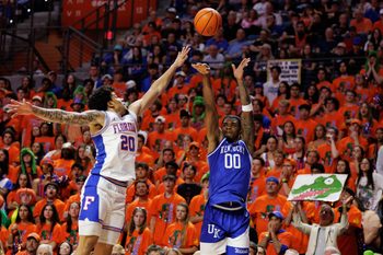 Feb 14, 2026; Gainesville, Florida, USA; Kentucky Wildcats guard Otega Oweh (00) shoots the ball over Florida Gators guard Isaiah Brown (20) during the first half at Exactech Arena at the Stephen C. O'Connell Center. Mandatory Credit: Matt Pendleton-Imagn Images
