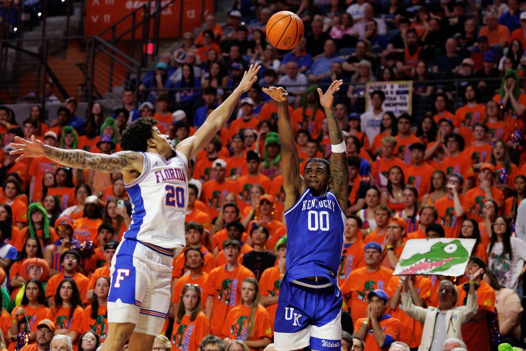 Feb 14, 2026; Gainesville, Florida, USA; Kentucky Wildcats guard Otega Oweh (00) shoots the ball over Florida Gators guard Isaiah Brown (20) during the first half at Exactech Arena at the Stephen C. O'Connell Center. Mandatory Credit: Matt Pendleton-Imagn Images