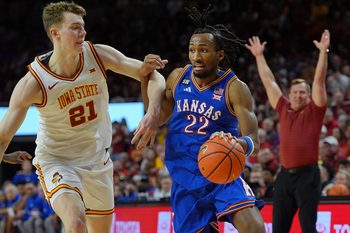 Kansas Jayhawks guard Darryn Peterson (22) drives with the ball as Iowa State Cyclones forward Dominykas Pleta (21) during the second half in the Big-12 conference basketball showdown on Feb. 14, 2026, at Hilton Coliseum, in Ames, Iowa.