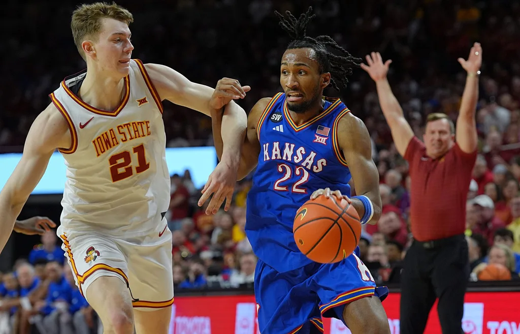 Kansas Jayhawks guard Darryn Peterson (22) drives with the ball as Iowa State Cyclones forward Dominykas Pleta (21) during the second half in the Big-12 conference basketball showdown on Feb. 14, 2026, at Hilton Coliseum, in Ames, Iowa.