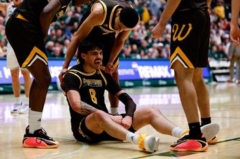 Feb 14, 2026; Fort Collins, Colorado, USA; Wyoming Cowboys forward Kiani Saxon (8) reacts with guard Damarion Dennis (1) after a play in the second half against the Colorado State Rams at Moby Arena. Mandatory Credit: Isaiah J. Downing-Imagn Images