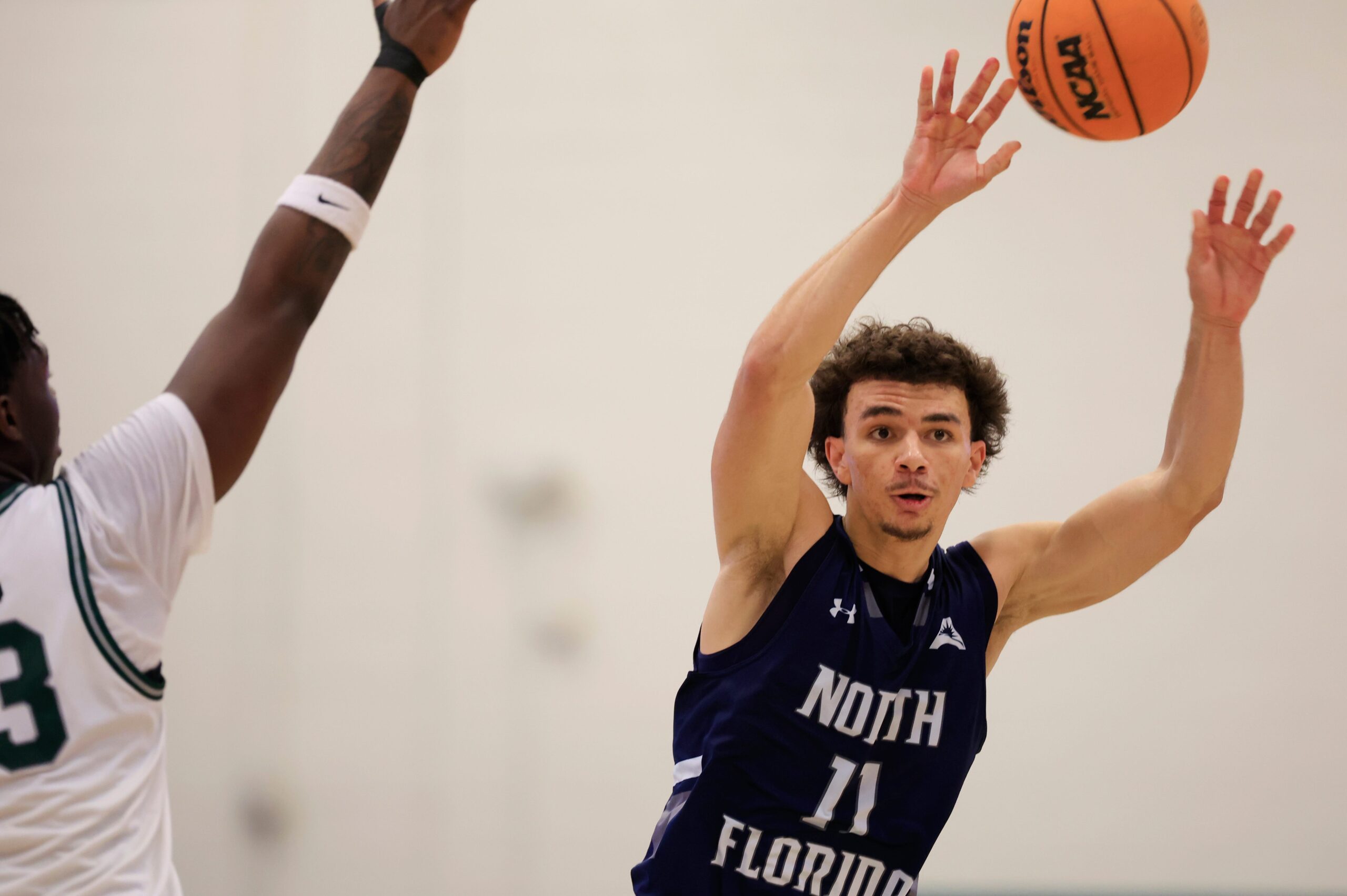 North Florida Ospreys guard Kamrin Oriol (11) passes the ball during the second half of an NCAA men’s basketball game at Swisher Gymnasium, Saturday, Feb. 14, 2026, in Jacksonville, Fla. JU held off UNF 63-56. [Corey Perrine/Florida Times-Union]