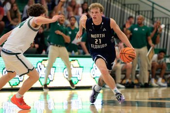North Florida Ospreys forward Dalton Gayman (21) defends against Jacksonville Dolphins guard Evan Sterck (34) during the second half of an NCAA men’s basketball game at Swisher Gymnasium, Saturday, Feb. 14, 2026, in Jacksonville, Fla. JU held off UNF 63-56. [Corey Perrine/Florida Times-Union]