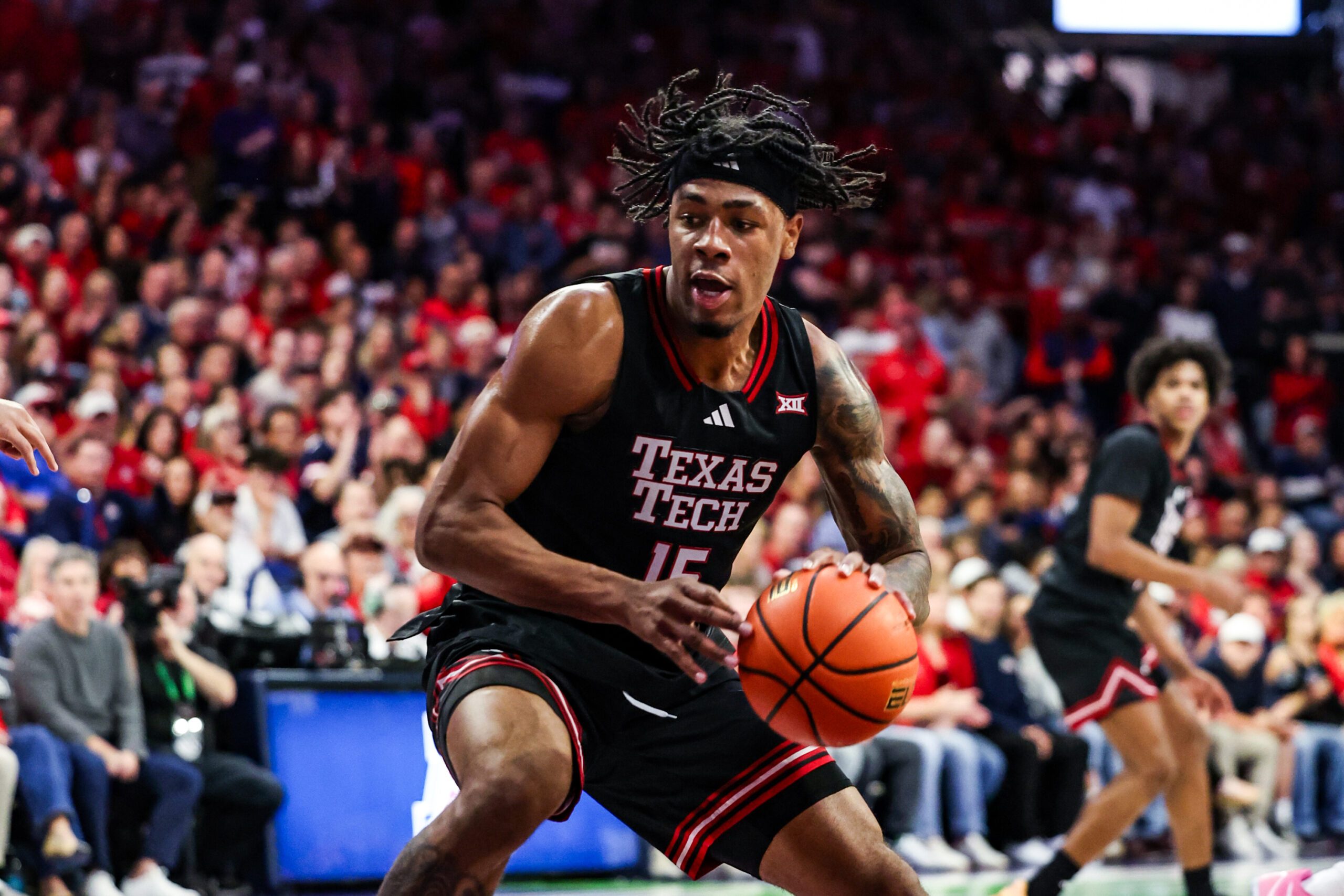 Feb 14, 2026; Tucson, Arizona, USA; Texas Tech Red Raiders forward JT Toppin (15) dribbles and dunks the ball during the first half of the game against the Arizona Wildcats at McKale Memorial Center. Mandatory Credit: Aryanna Frank-Imagn Images